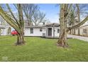 Charming ranch house with landscaped lawn and mature trees at 4048 Breton St, Indianapolis, IN 46222