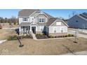 Two-story house with gray siding and a large backyard at 4416 Voyageur Way, Carmel, IN 46074