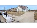 House exterior showcasing driveway and landscaping at 4416 Voyageur Way, Carmel, IN 46074