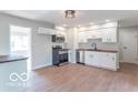 Updated kitchen with stainless steel appliances and wood-look flooring at 10138 Catalina Dr, Indianapolis, IN 46235