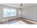 Bright living room featuring hardwood floors and large windows at 10138 Catalina Dr, Indianapolis, IN 46235
