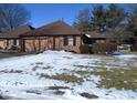 Brick ranch home with snow-covered lawn at 1114 Willow Springs Blvd, Brownsburg, IN 46112