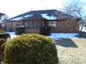 Brick ranch home with sunroom and snow at 1114 Willow Springs Blvd, Brownsburg, IN 46112
