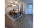 Bright dining room featuring a wood table, bench seating, and light flooring at 1271 N Manchester Dr, Greenfield, IN 46140