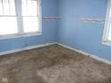 Small bedroom with light blue walls and dirty carpet at 1300 W 13Th St, Muncie, IN 47302
