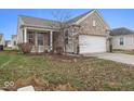 Brick ranch home with attached garage and landscaped front yard at 15977 Marsala Dr, Fishers, IN 46037