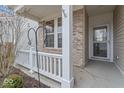 Covered front porch with white railings and brick columns at 15977 Marsala Dr, Fishers, IN 46037