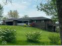 Brick ranch home with a spacious yard and attached garage at 3163 S 25 E, Shelbyville, IN 46176