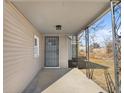 Covered porch with a metal security door at 320 W 6Th St, Muncie, IN 47302