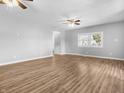 Spacious living room with hardwood floors and ceiling fans at 320 W 6Th St, Muncie, IN 47302