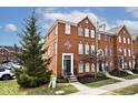 Beautiful brick townhome featuring a well-manicured front yard and classic architectural details at 335 Autumn Dr, Carmel, IN 46032