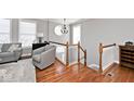 Cozy living area with hardwood floors, a staircase, and a bright, inviting atmosphere at 335 Autumn Dr, Carmel, IN 46032