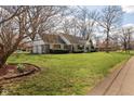 Single Gathering home featuring a well-manicured lawn and mature trees at 3521 Manchester Rd, Anderson, IN 46012