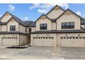 View of a townhouse highlighting a two-car garage, contemporary architecture, and tasteful landscaping at 4183 Douro Trl, Westfield, IN 46062