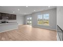 Bright living space boasts wood floors, a view of the yard, and an open layout to the kitchen at 4183 Douro Trl, Westfield, IN 46062
