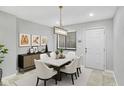 Modern dining room with a marble table and white chairs at 4218 Indian Pipe Trce, Indianapolis, IN 46237