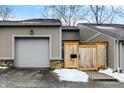 Townhouse exterior featuring a private entrance and attached garage at 4218 Indian Pipe Trce, Indianapolis, IN 46237