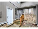 Front entrance of a townhouse with stone accents and wooden stairs at 4218 Indian Pipe Trce, Indianapolis, IN 46237