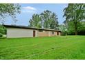 Expansive backyard featuring lush lawn and mature trees, offering privacy and space for outdoor activities at 4820 E 70Th St, Indianapolis, IN 46220