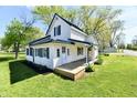 Beautifully maintained two-story home with a green roof and a well manicured lawn at 4992 W 100 S, New Palestine, IN 46163