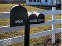 Three mailboxes on a white post and rail fence at 5420 Mcfarland Rd, Indianapolis, IN 46227