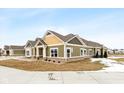 Side view of charming craftsman style home with gray and yellow exterior at 6207 Preserve Way, McCordsville, IN 46055