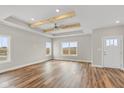 Spacious living room with hardwood floors, exposed beams, and lots of natural light at 6207 Preserve Way, McCordsville, IN 46055