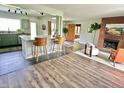 Bright and airy living space with an open floor plan, featuring a kitchen island and cozy fireplace at 6220 Dean Rd, Indianapolis, IN 46220