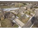 Aerial view of houses and neighborhood with partial snow cover at 7059 Koldyke Pl, Fishers, IN 46038