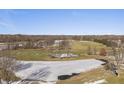 Frozen pond and trees in a winter landscape at 7059 Koldyke Pl, Fishers, IN 46038