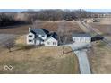 Aerial view of a two-story home with an attached and detached garage on a rural lot at 9222 W State Road 38, Lapel, IN 46051