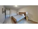 Bedroom with wood bed frame and neutral color scheme at 104 Rush Ct, Fishers, IN 46038