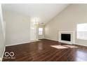 Bright living room with hardwood floors, high ceilings, and a fireplace at 13398 N Largo Ct, Camby, IN 46113