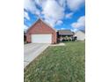 Brick ranch home with attached garage and well-maintained lawn at 134 President W Trl, Indianapolis, IN 46229