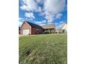 Brick ranch home with attached garage and spacious lawn at 134 President W Trl, Indianapolis, IN 46229