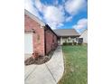 Brick ranch home with attached garage and walkway at 134 President W Trl, Indianapolis, IN 46229