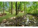 Picturesque backyard with a creek, mature trees, and plenty of space for recreation and relaxation at 14565 Geist Ridge Dr, Fishers, IN 46040