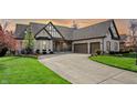 Attractive light brick home boasting a large driveway and well-maintained landscaping at 14565 Geist Ridge Dr, Fishers, IN 46040