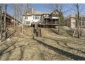 Backyard view showcasing multi-level decks and wooded scenery at 14565 Geist Ridge Dr, Fishers, IN 46040