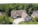 Aerial view of a house with a large backyard and driveway at 14565 Geist Ridge Dr, Fishers, IN 46040