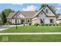 Brick house with a gabled roof and manicured lawn at 14565 Geist Ridge Dr, Fishers, IN 46040
