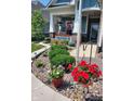 Landscaped front yard with colorful flowers, shrubs, and rock bed at 1574 Leisure Way, Greenfield, IN 46140