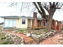 Cozy home featuring a brick chimney, stone-lined garden, and a serene backyard retreat at 252 Ringwood Way, Anderson, IN 46013