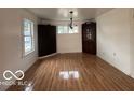 Bright dining room features hardwood floors and built-in corner cabinets at 252 Ringwood Way, Anderson, IN 46013
