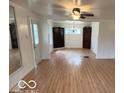 Bright living room with hardwood floors, ample space, updated light fixtures, and neutral paint at 252 Ringwood Way, Anderson, IN 46013
