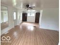 Bright living room with hardwood floors, ample space, updated light fixtures, and neutral paint at 252 Ringwood Way, Anderson, IN 46013