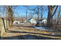 Large backyard with mature trees and a wooden fence at 2925 Stuart St, Indianapolis, IN 46218