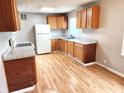 Spacious kitchen with wooden cabinets, white appliances, and ample counter space, perfect for meal preparation at 3513 N Layman Ave, Indianapolis, IN 46218