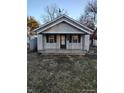 Charming single-story home featuring a covered front porch with classic black accents and a well-maintained lawn at 3619 N Hawthorne Ln, Indianapolis, IN 46218
