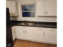 Simple kitchen with white cabinets and dark countertop at 4013 Patricia St, Indianapolis, IN 46222